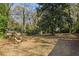 Large backyard with mature trees and wooden chair at 2930 Kimmeridge Dr, Atlanta, GA 30344