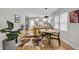 Open concept dining area features a cowhide rug and mid century modern furniture at 2930 Kimmeridge Dr, Atlanta, GA 30344