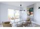 Elegant dining room with marble table, modern light fixture, and access to outdoor patio at 380 Hillcrest View Dr, Suwanee, GA 30024