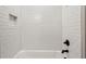 Clean bathroom with white subway tile, bathtub, and modern fixtures at 1095 Tucker Ave # 501, Atlanta, GA 30310