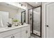 Double vanity bathroom with a frameless glass shower and grey tile at 1095 Tucker Ave # 501, Atlanta, GA 30310