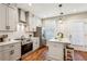 Modern kitchen with white shaker cabinets, stainless steel appliances, and white quartz countertops at 1095 Tucker Ave # 501, Atlanta, GA 30310