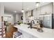 Open concept kitchen features island with seating, stainless steel appliances and hardwood floors at 1095 Tucker Ave # 501, Atlanta, GA 30310