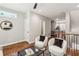 Open living room with hardwood floors and access to kitchen and balcony at 1095 Tucker Ave # 501, Atlanta, GA 30310