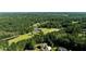 Aerial view of a house on a large lot with a pond nearby at 307 Cinnamon Bark Pass, Locust Grove, GA 30248
