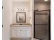 Bathroom with granite countertop, white cabinets, and shower at 307 Cinnamon Bark Pass, Locust Grove, GA 30248