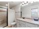 Double vanity bathroom with granite countertops and shower at 307 Cinnamon Bark Pass, Locust Grove, GA 30248