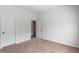 Bedroom with carpet and door to hallway at 307 Cinnamon Bark Pass, Locust Grove, GA 30248
