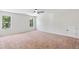 Spacious bedroom with carpet, two windows, and ceiling fan at 307 Cinnamon Bark Pass, Locust Grove, GA 30248