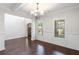 Spacious dining room with hardwood floors and chandelier at 307 Cinnamon Bark Pass, Locust Grove, GA 30248