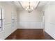 Bright dining room with hardwood floors and elegant chandelier at 307 Cinnamon Bark Pass, Locust Grove, GA 30248