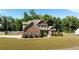 Two story brick house with landscaping at 307 Cinnamon Bark Pass, Locust Grove, GA 30248