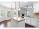 Eat-in kitchen, granite island, white cabinets, and hardwood floors at 307 Cinnamon Bark Pass, Locust Grove, GA 30248