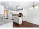 Modern kitchen with granite counters, white cabinets, and kitchen island at 307 Cinnamon Bark Pass, Locust Grove, GA 30248