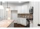 Kitchen with white cabinets, granite countertops and stainless steel appliances at 307 Cinnamon Bark Pass, Locust Grove, GA 30248