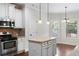 Kitchen with island, white cabinets, granite countertops at 307 Cinnamon Bark Pass, Locust Grove, GA 30248