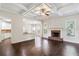 Spacious living room with hardwood floors, a brick fireplace, and coffered ceilings at 307 Cinnamon Bark Pass, Locust Grove, GA 30248
