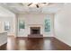 Living room with hardwood floors, brick fireplace and large windows at 307 Cinnamon Bark Pass, Locust Grove, GA 30248