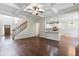 Open floor plan with hardwood floors, kitchen island, and staircase at 307 Cinnamon Bark Pass, Locust Grove, GA 30248