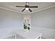 Bright dining area with white table, ceiling fan and view into kitchen at 315 Lakestone Lndg, Woodstock, GA 30188