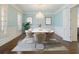 Formal dining room with hardwood floors, wainscoting, chandelier, and seating for eight at 335 Enclave Cir, Atlanta, GA 30342