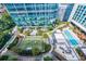 Aerial view of a building with a pool, green space, and city views at 40 12Th Ne St # 1701, Atlanta, GA 30309