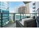 A modern balcony with wicker chairs and a glass railing offering great city views at 40 12Th Ne St # 1701, Atlanta, GA 30309