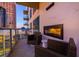 A cozy balcony with two wicker chairs and fireplace, offering stunning city views at 40 12Th Ne St # 1701, Atlanta, GA 30309