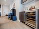 Stylish bar area with wine fridge conveniently located near a piano and seating area at 40 12Th Ne St # 1701, Atlanta, GA 30309