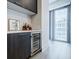 Wet bar area with a wine fridge and access to a balcony with city views at 40 12Th Ne St # 1701, Atlanta, GA 30309