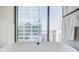 Close-up of a modern soaking tub with a stunning cityscape view from the bathroom at 40 12Th Ne St # 1701, Atlanta, GA 30309