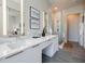 Bright bathroom with double sink vanity, modern fixtures, and a glass-enclosed shower with tile flooring at 40 12Th Ne St # 1701, Atlanta, GA 30309