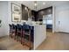 Modern kitchen featuring dark wood cabinets, stainless steel appliances, and a large island with bar seating at 40 12Th Ne St # 1701, Atlanta, GA 30309