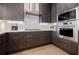 A contemporary kitchen featuring dark wood cabinetry, stainless steel appliances, and hardwood floors at 40 12Th Ne St # 1701, Atlanta, GA 30309