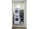Convenient laundry closet features stacked washer and dryer, and storage shelving at 40 12Th Ne St # 1701, Atlanta, GA 30309