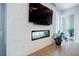 Bright living area with a modern fireplace, TV, and a view leading to a balcony at 40 12Th Ne St # 1701, Atlanta, GA 30309