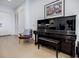 Elegant living room features a piano, chair, and artwork near the front entrance at 40 12Th Ne St # 1701, Atlanta, GA 30309