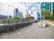 Relaxing rooftop patio with bar stools, fire table, and scenic city views at 40 12Th Ne St # 1701, Atlanta, GA 30309