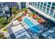 Aerial view of a stunning rooftop pool with plenty of lounge seating and umbrellas at 40 12Th Ne St # 1701, Atlanta, GA 30309