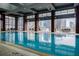 Indoor swimming pool with lounge seating areas and big windows overlooking the city skyline at 40 12Th Ne St # 1701, Atlanta, GA 30309