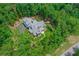 Luxury home nestled in a wooded lot, aerial view at 106 Laurel Brook Ln, Canton, GA 30115