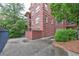 Exterior view of brick building with private patio and lush landscaping at 1735 Peachtree Ne St # 129, Atlanta, GA 30309