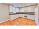 Eat-in kitchen with white cabinets, granite counters, and hardwood floors at 1735 Peachtree Ne St # 129, Atlanta, GA 30309