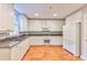 Kitchen with white cabinets, granite countertops, hardwood floors at 1735 Peachtree Ne St # 129, Atlanta, GA 30309