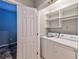 Well-appointed laundry room with washer, dryer, and shelving at 1735 Peachtree Ne St # 129, Atlanta, GA 30309