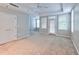 Main bedroom with plush carpet, neutral walls, and access to a private patio at 1735 Peachtree Ne St # 129, Atlanta, GA 30309