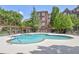 Community pool with surrounding lounge chairs and brick building in background at 1735 Peachtree Ne St # 129, Atlanta, GA 30309