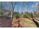 Landscaped backyard with mature trees at 4187 Westchester Ne Trce, Roswell, GA 30075