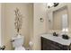 Small bathroom with dark vanity and decorative wall art at 4187 Westchester Ne Trce, Roswell, GA 30075