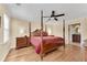 Spacious bedroom with hardwood floors and a large four-poster bed at 4187 Westchester Ne Trce, Roswell, GA 30075